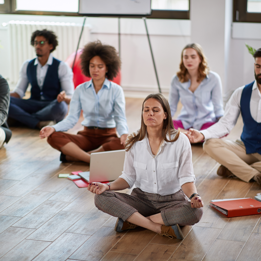 Group Meditation corporate seated on wooden floor