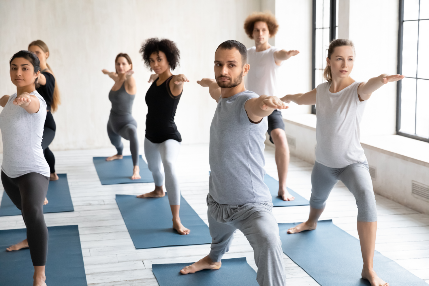 Origins Unity LLC: Beginners Yoga Warrior Two Pose for holistic well-being